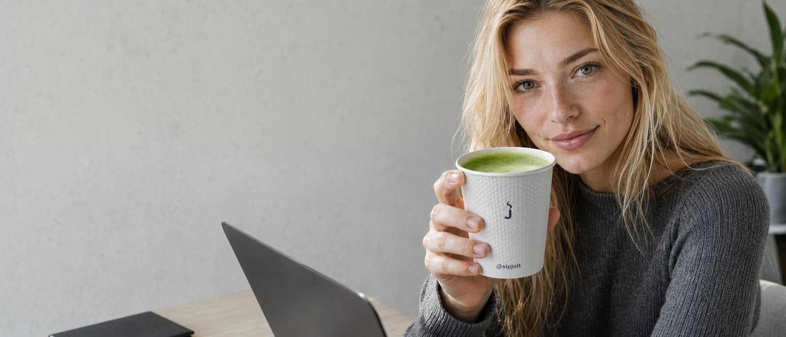 A SIPJOLT cup of fresh matcha, enjoyed at a sunlit desk
